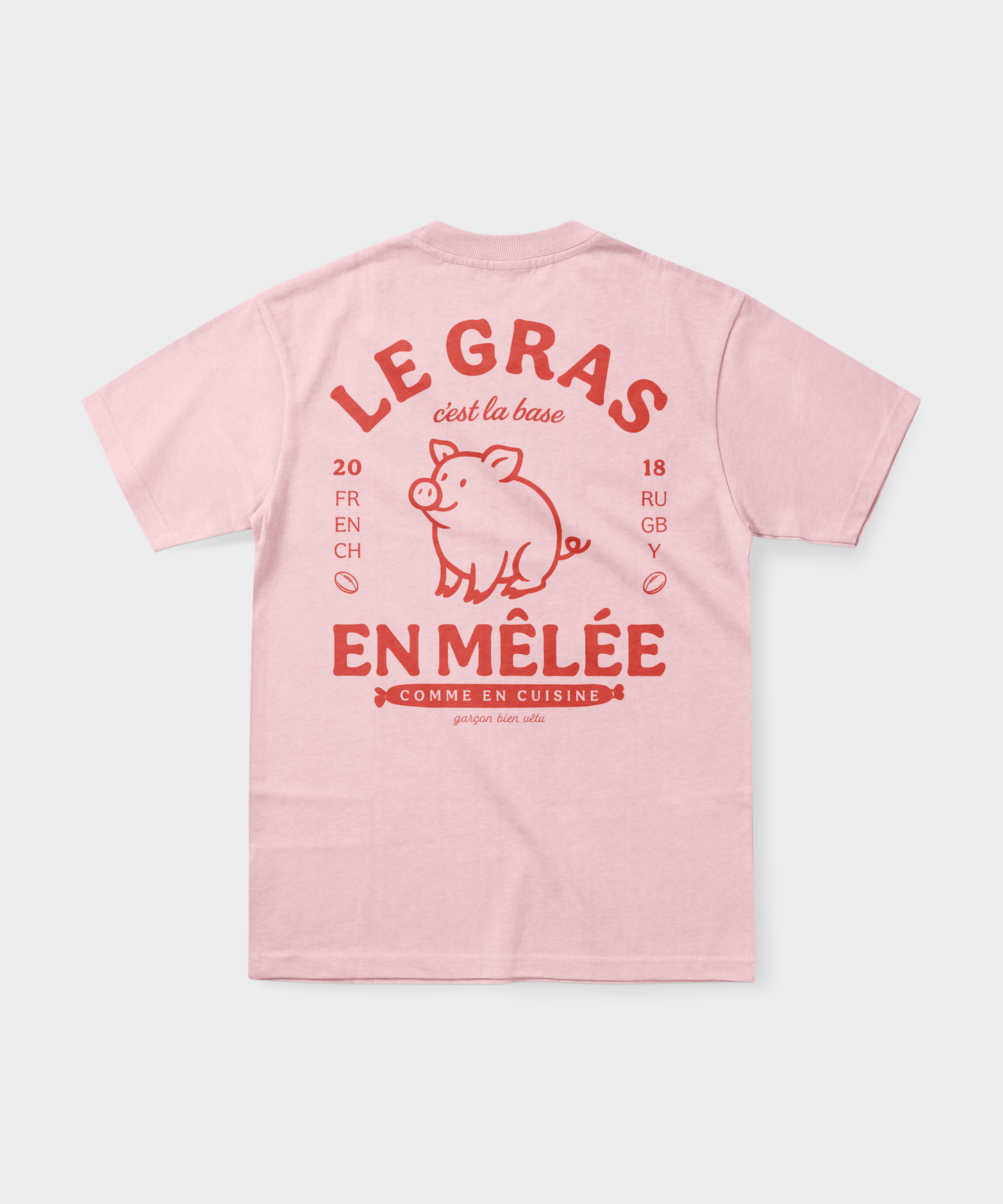 T-shirt rugby rose pâle avec illustration de cochon et texte rouge "Le gras c'est la base en mêlée".